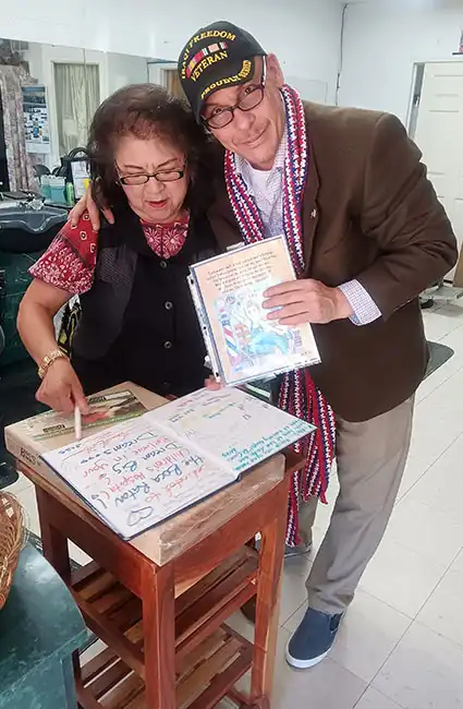 Author David Haave signing books for Mrs. Kim at her barbershop. Military cuts for all soldiers on Ft Wood Army Base, MO, USA.